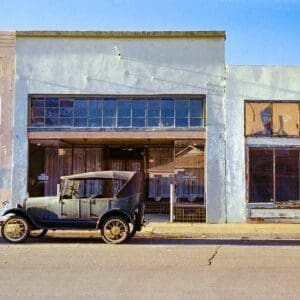 Ford Model T Nostalgic Photography Print featuring a vintage car and historic buildings at golden hour