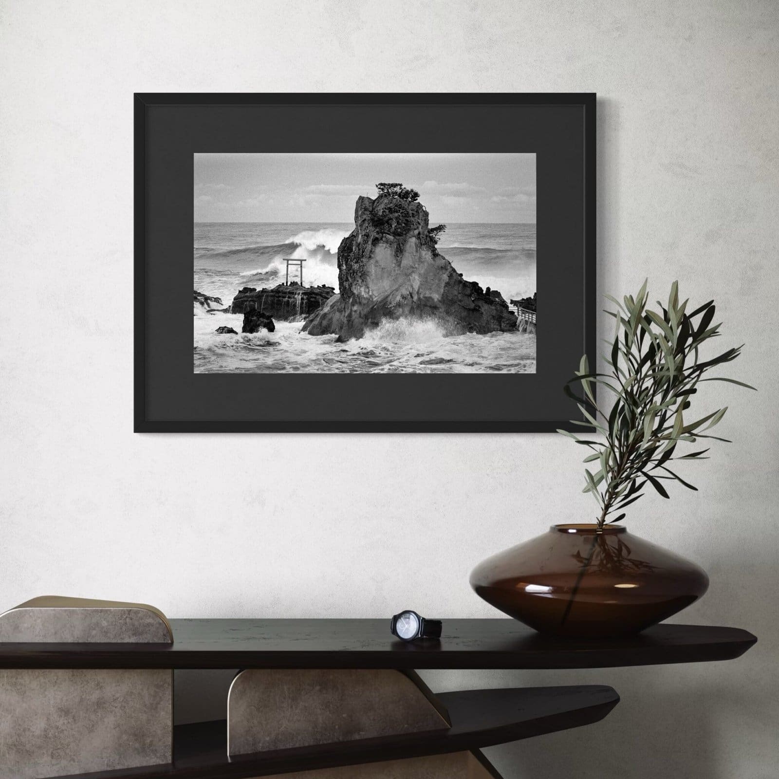 Black-and-white seascape photograph with Torii gate in modern interior setting.
