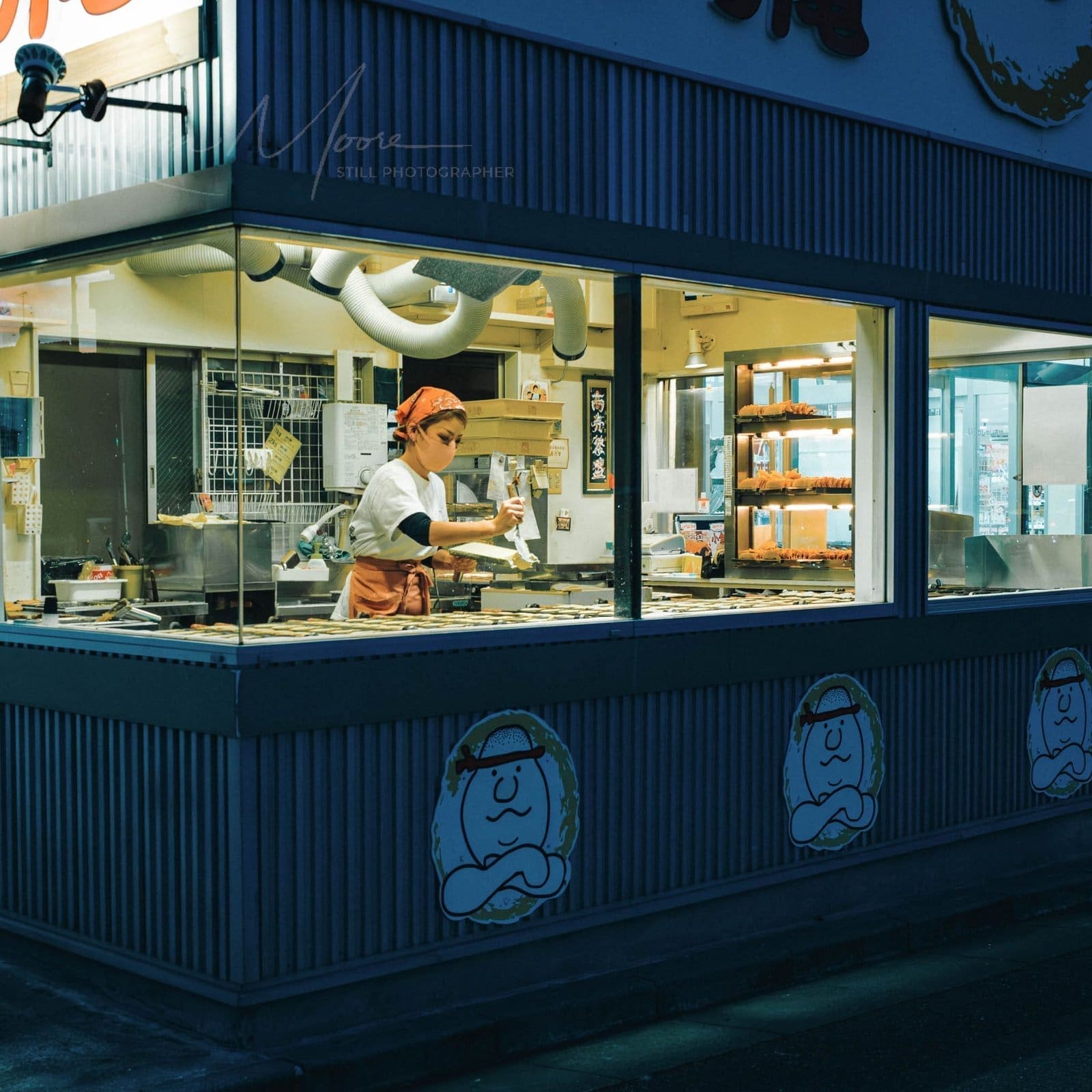Late-Night Taiyaki Baking Session Evening bakery scene showing employee preparing Taiyaki (鯛焼き).