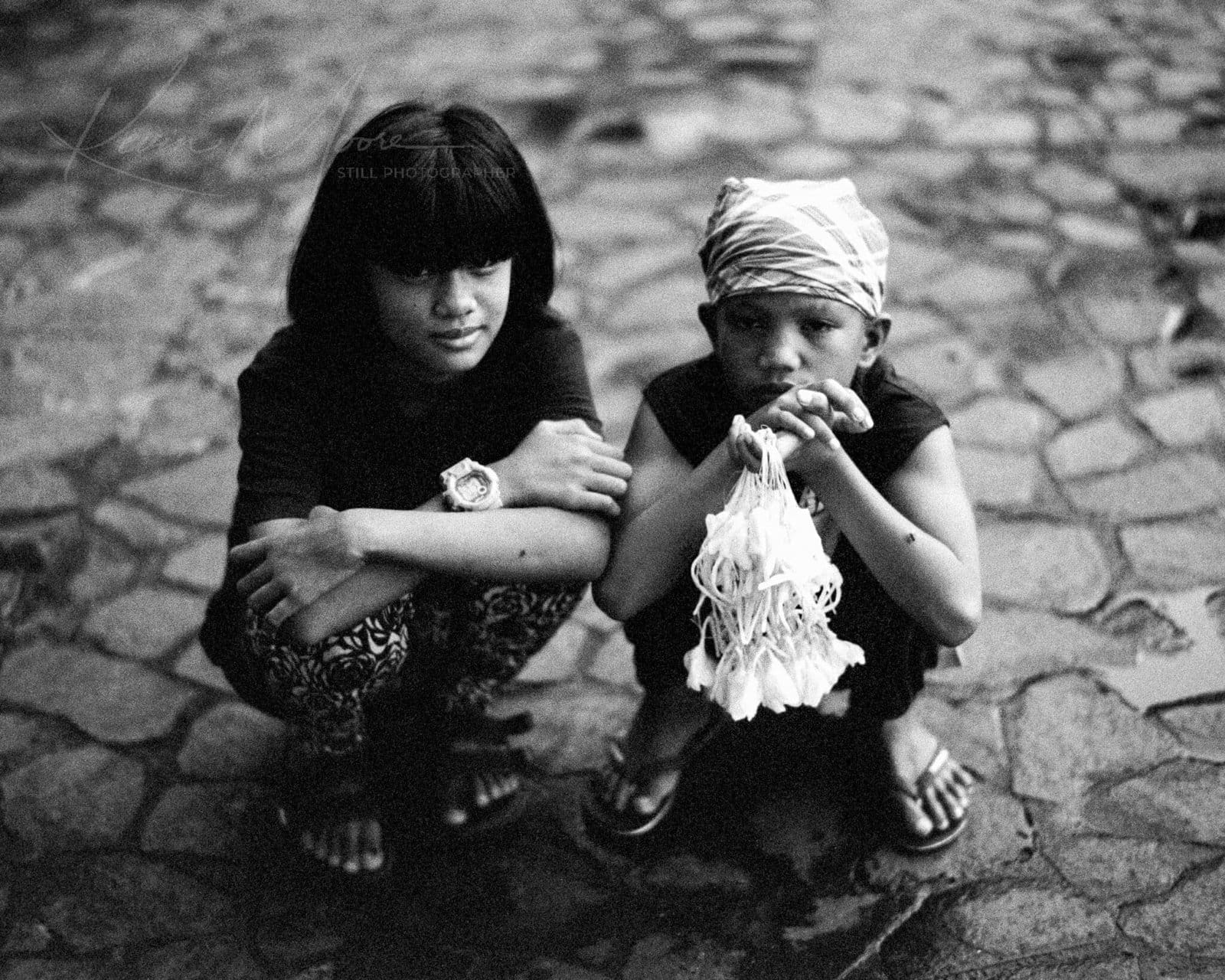 Siblings of Pampanga: A Monochrome Moment B&W Film photograph of children selling Sampaguita flowers in the Philippines